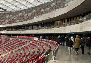 Uczestnicy wycieczki zwiedzają Trybunę dolną Stadionu Narodowego PGE.