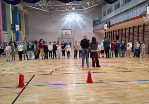 Uczniowie klasy 2a i 2e wraz z wychowawczyniami czekają na rozpoczęcie konkurencji sportowych.