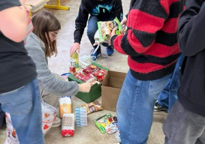 Uczniowie z klasy 8b pomagają w przygotowaniu paczek