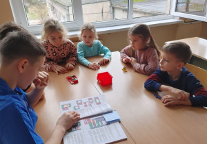 Uczniowie z klas szóstych i siódmych pomagają przedszkolakom w tworzeniu robota Lego Spike.